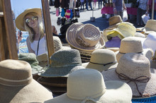 Young Lady At Flea Market Wearing Hat In Mirror