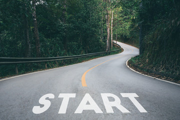 startup to success business printed on road leading towards future concept.