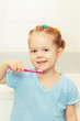 © alexeytsurkan - Little girl brushing her teeth in the bathroom. Smiling child holding a toothbrush.