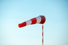 Horizontally Flying Windsock (wind Vane) Due To High Wind. Blue Sky In The Background. Success Concept.