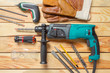 © fotofabrika - Electric hammer drill lies on a wooden table