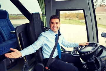 happy driver inviting on board of intercity bus