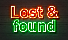 Lost & Found Neon Sign On Brick Wall Background.