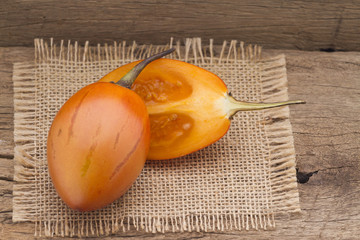 Wall Mural - Tamarillo fruit (disambiguation) from South America, on wooden background