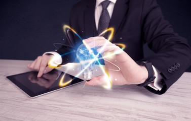 businessman holding a colorful light bulb