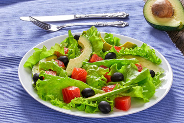 Wall Mural - salad of  lettuce, avocado, chunks of salted salmon