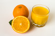 Oranges and glass of juice on a white background.