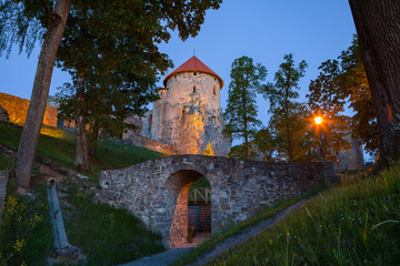 View of beautiful ruins of ancient Livonian castle in old town of Cesis, Latvia. Greenery and summer evening.