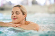 Middle-aged woman enjoying thermal bath in thalassotherapy center