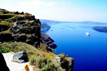 Wall Mural - Piece of Mediterranean cruise On Santorini island, Greece. The view from the hotel on the lower terrace and the shore of the Aegean sea. characteristic architecture blue and white tones in the decor