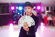 Magician showing trick with playing cards. Magic, circus