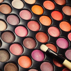 Closeup of make-up eye shadows with makeup brush. Makeup palette with brush