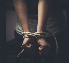 Detail Of Female Hands Tied Up With Rope