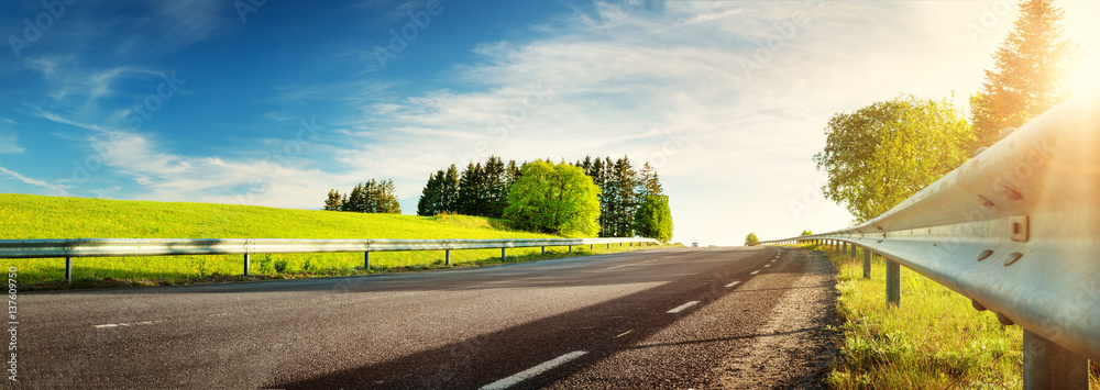 asphalt road panorama in countryside on sunny spring evening - obrazy, fototapety, plakaty 