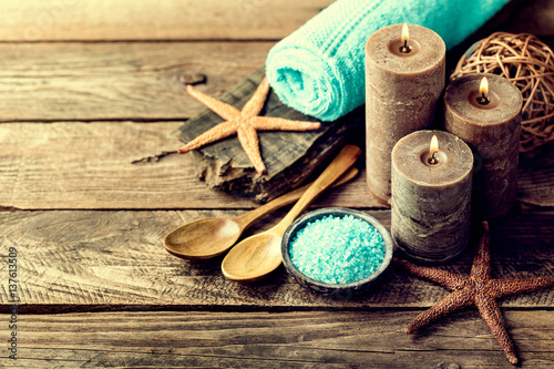Set for spa treatments with cosmetic products for body care and relaxation on wooden background with space for a text