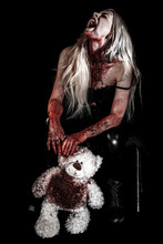 Bloody Young Woman Holding A Teddy Bear