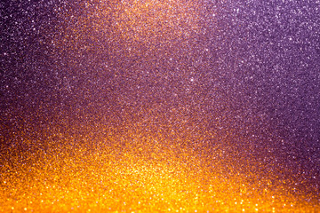 Wall Mural - Abstract background filled with shiny gold and purple glitter