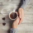 lovers holding together a Cup of tea. Selective focus.  