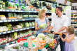 © JackF - Family picking greens in food store.