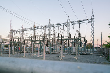 Impression network at transformer station in sunrise, high voltage up to twilight sky.
High-voltage wires and transformers. Electrical distribution station.