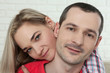 © missty - Cheerful young couple looking at camera closeup at home