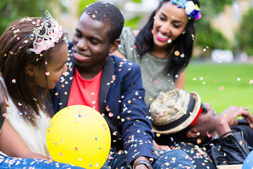 Indian girl and african couple celebrating together on street party