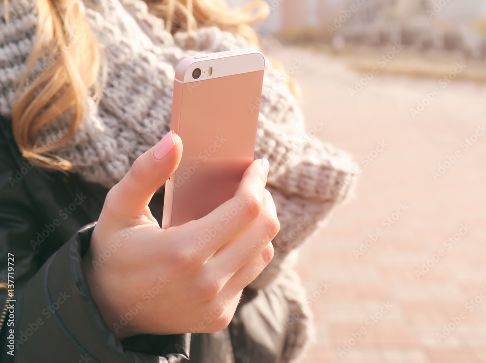 Closeup of female hand holding smartphone