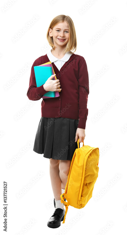 Cute girl in school uniform with backpack and books on white background