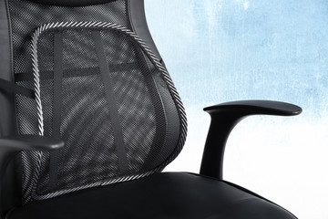 Office chair with mesh for back support on light background