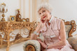 © Yakobchuk Olena - Elegant senior woman sitting on luxury armchair