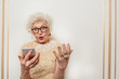 © Yakobchuk Olena - Puzzled old lady does not understand modern technology