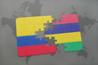 puzzle with the national flag of colombia and mauritius on a world map