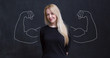 © Myvisuals - Young woman against the background of depicted muscles on chalkboard