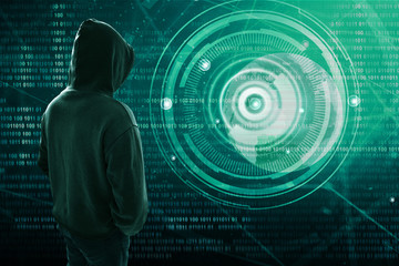 Wall Mural - Hacker standing over a screen with binary code