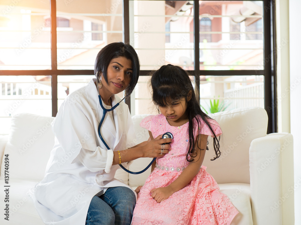 indian female doctor treating young girl patient Stock Photo | Adobe Stock