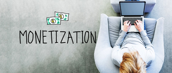 Wall Mural - monetization text with man using a laptop