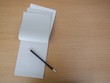 notepad open on an empty page with pencil