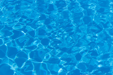 blue and bright water with sun reflection