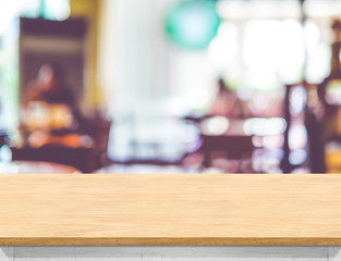 Poster - Empty wood table top with blurred cafe background. Mock up for display or montage of product,Business presentation