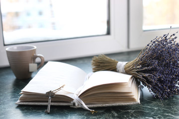 Wall Mural - Vintage notebook on green marble windowsill opened with blank pages and lavender