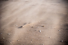 Closeup Of Sand Blowing Across Beach In Sandstorm
