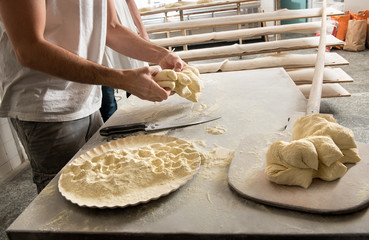 Wall Mural - Male baker working with dough