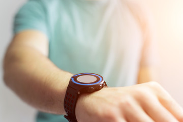 Hand holding black smartwatch with technology screen