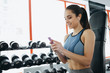 © alexshutter95 - Portrait of young and attractive woman in blue top in gym.