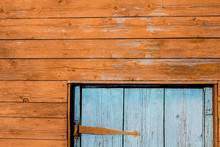 Fragment Of A Wooden House. Orange Wall And Blue Door.