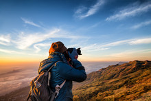 Beautiful Women Professional Photographer Takes Images With DSLR Camera., On The Mountain With Morning Sunlight And Fog.