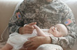 Military father holding his newborn baby