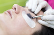 Woman on the procedure for eyelash extensions, eyelashes lamination 