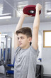 Teenage boy engaged in the gym hall 