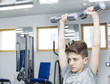 Teenage boy engaged in the gym hall 